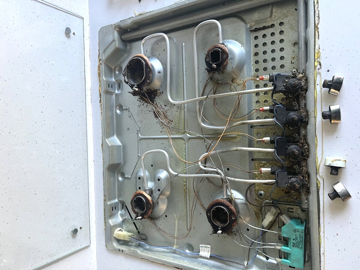 Gas hob repair, burners and ignition components exposed
